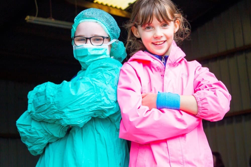 Two of our members, one wearing a surgical mask and the other smiling