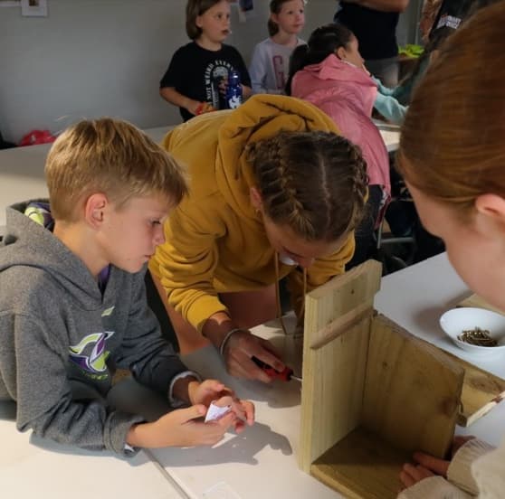 YVC members building a wooden bird house